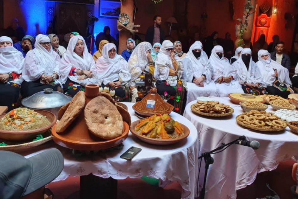 This image bears witness to a moment of collective devotion at the Moussem in Agadir. Through shared food, white garments, and quiet presence, it shows culture being preserved not as display, but as lived ritual felt through taste, rhythm, and communal stillness.